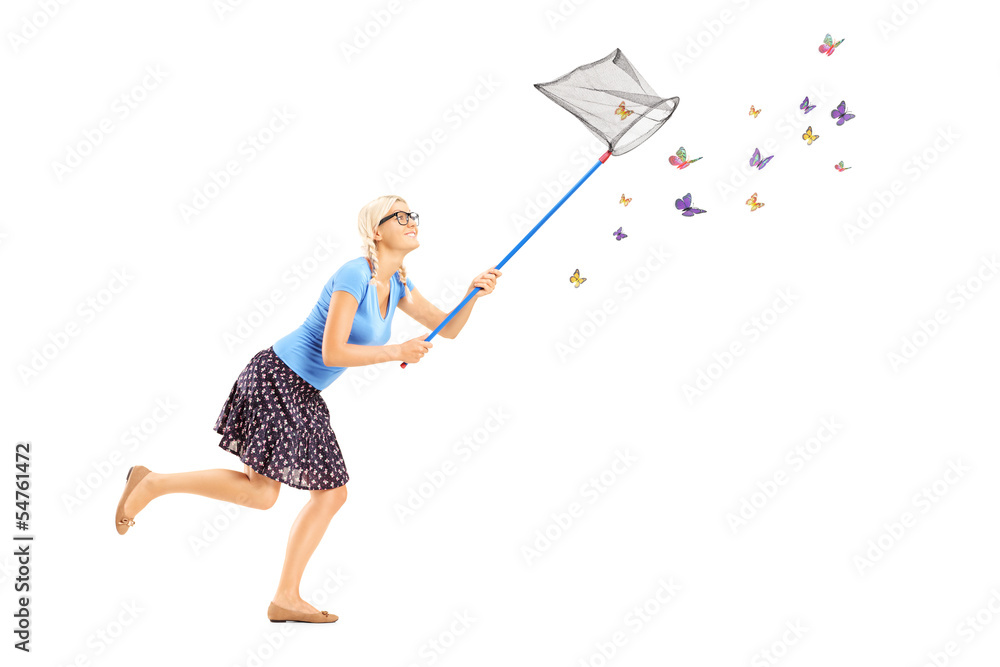 Wall mural full length portrait of a woman running and catching butterflies