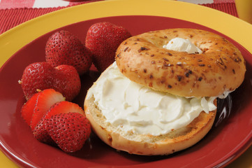 Toasted bagel with cream cheese and strawberries