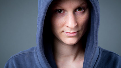 A young woman wearing a hooded sweater