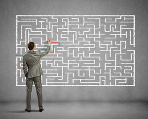 Businessman solving labyrinth problem