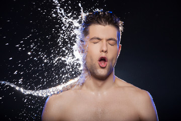 Water on face. Portrait of young wet men and the water splashing