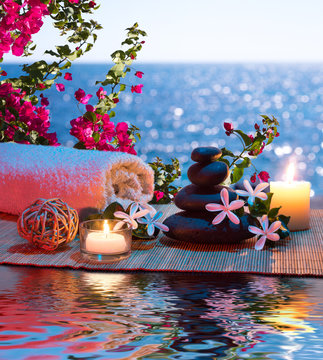 Candles - black stones and tiare - Bougainvillea on water