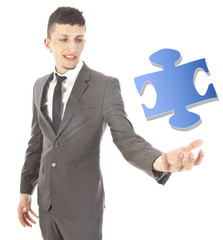 Young man with puzzle piece isolated on white background