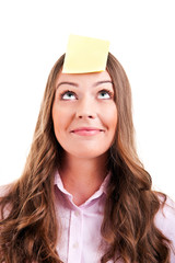 Young woma with yellow sticky note on forehead