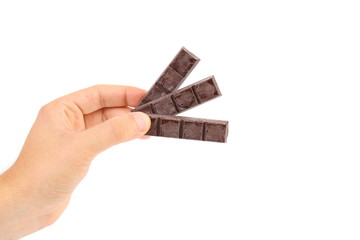 Hand holds three chocolate bars.