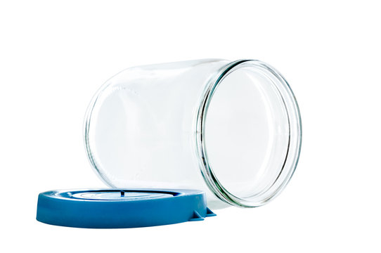 Transparent glass jar on white background, with the open plastic blue top