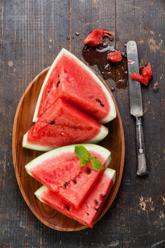Watermelon slices on wooden background