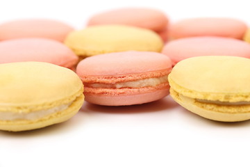Background of seven various  macaron cakes.