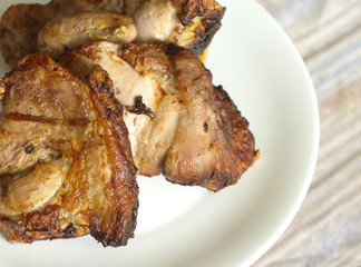 Appetizing fried meat pieces on white plate close up