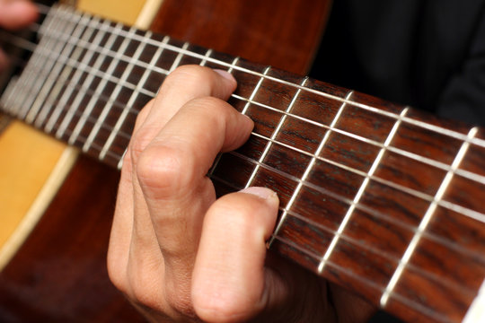 musician playing an acoustic guitar