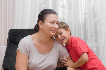 Obraz premium Happy mother with her son in interior