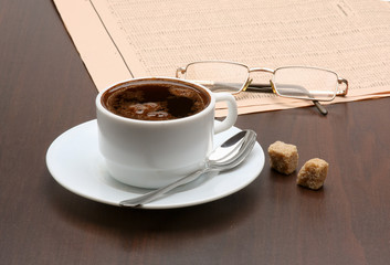 Cup of coffee and newspaper