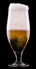 Frosty glass of light beer on black background