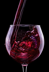 Elegant red wine glass in black background