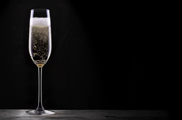 Fotobehang glass of champagne isolated on black background © boule1301