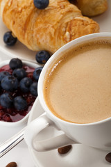 coffee with croissants and blueberries on white background