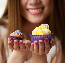 Woman holding a cup cake
