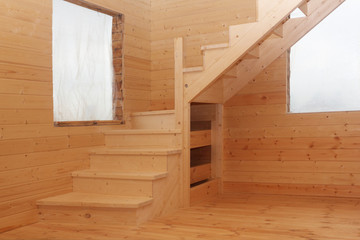 Wooden loft stairs in corner under conctruction