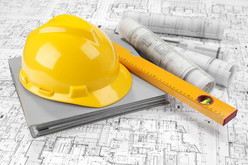 Yellow helmet, level, grey folder document and project drawings
