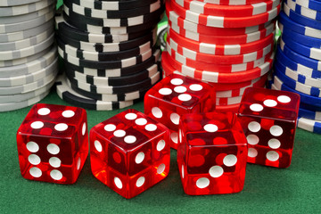 Red dice and chips on a green felt