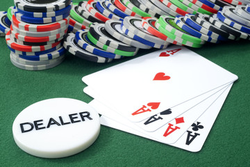 Four aces and chips on a green felt
