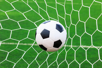 Obraz na płótnie Canvas soccer ball in goal net