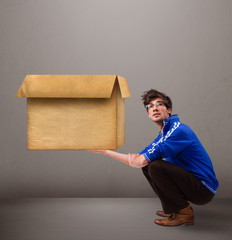 Goog-looking man holding an empty brown cardboard box