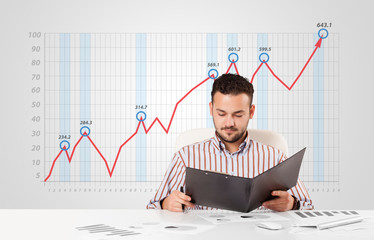 Businessman calculating stock market with rising graph in the ba