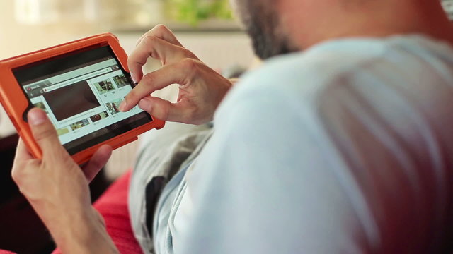 Man browsing internet on tablet computer