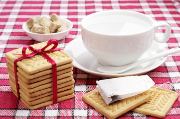 Cookies, cup with hot water and tea bag