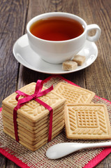 Obraz na płótnie Canvas Cookies tied ribbon and cup of tea