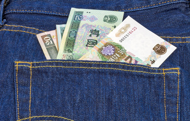 Chinese mone in the back pocket of a pair of blue jeans