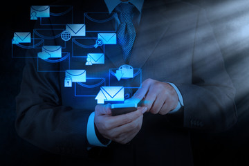businessman hand use smart phone computer with email icon