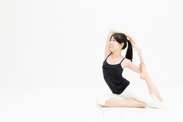 attractive asian woman exercising on white background