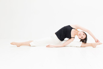 attractive asian woman exercising on white background