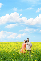 Happy man and woman in yellow meadow