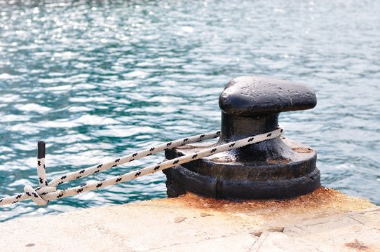 Marine rope on mooring bollard in port of Podgora, Croatia