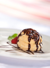 Chocolate profiteroles with ice cream on a plate