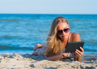 woman on the beach with a digital tablet