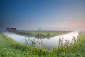 calm summer misty morning over river