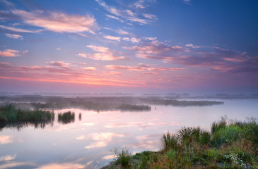 Fototapeta na wymiar warm summer sunrise over river