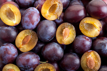 Fototapeta premium Background of the half and the whole plums