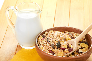 Plate with raw oatmeal on wooden table.