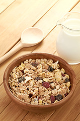 Plate with raw oatmeal on wooden table.