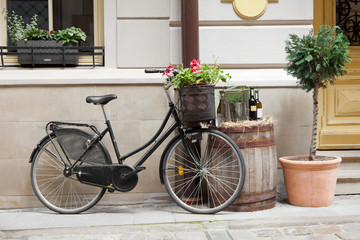 Fototapeta na wymiar Old bicycle carrying flowers