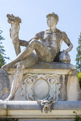 Stone male statue in Peles castle garden, Sinaia, Romania