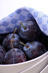 Pflaumen, Zwetschken in Porzelanschale, Tuch