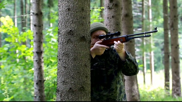 Man with optical rifle  and  binoculars in the woods episode 4