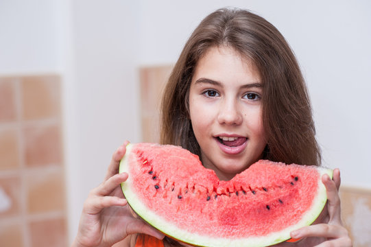 Beautiful teen girl with slice of fresh watermelon