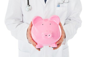 Male Doctor With Piggy Bank